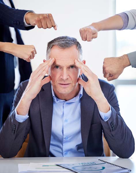 Portrait of a mature businessman looking stressed out in a deman